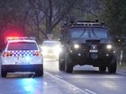 Police continue to search the alpine terrain for an armed fugitive who allegedly killed two officers. 