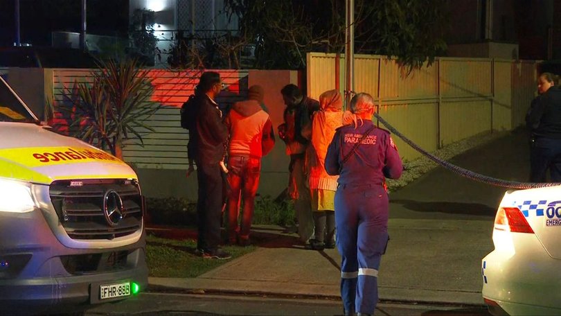 Man, women stabbed in front of children in a horror home invasion at Guildford West in Sydney.