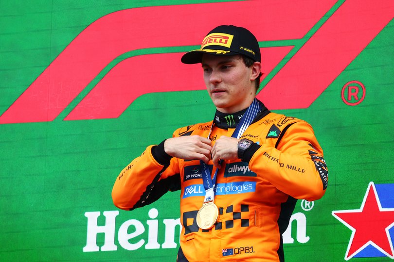 Race winner Oscar Piastri of Australia and McLaren celebrates on the podium.