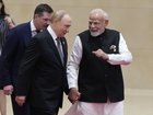 Indian Prime Minister Narendra Modi  walks next to Russian President Vladimir Putin.