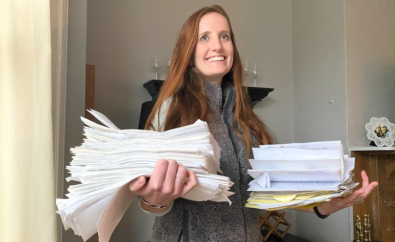 Paulik holding some of the letters her father has written her.