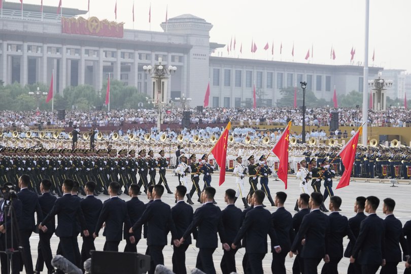 Spectators and military personnel gather for the military parade to commemorate the 80th anniversary of Japan's World War II surrender.