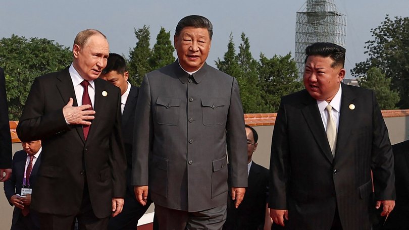Vladimir Putin walks with Xi Jinping and Kim Jong Un.