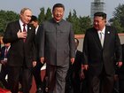 Vladimir Putin walks with Xi Jinping and Kim Jong Un.  