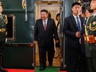 Kim Jong Un is all smiles as he disembarks in Beijing.