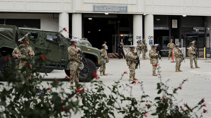 Members of the California National Guard stand outside the Edward R. Roybal Federal Building in downtown Los Angeles.