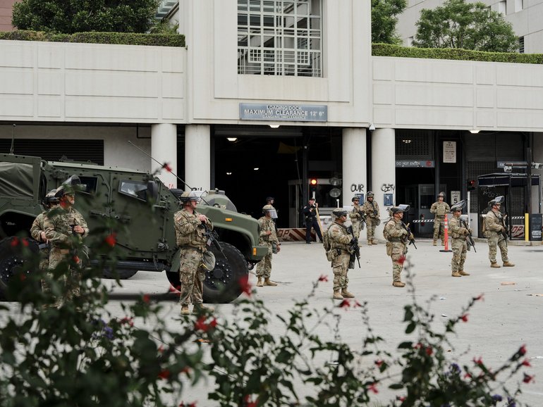 Members of the California National Guard stand outside the Edward R. Roybal Federal Building in downtown Los Angeles.
