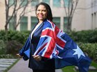 Jacinta Nampijinpa Price poses with an Australian Flag at Parliament House in Canberra. 
