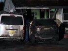 Four people were evacuated when a car was torched, and the flames spread to a Smithfield home on Friday morning.