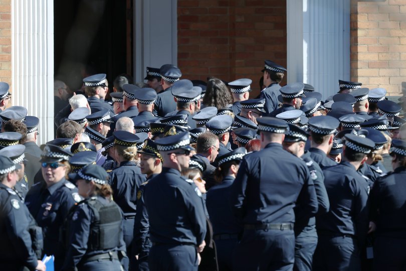 Police members and mourners arrive for the funeral service for Victoria Police officer, Senior Constable Vadim De Waart-Hottart.