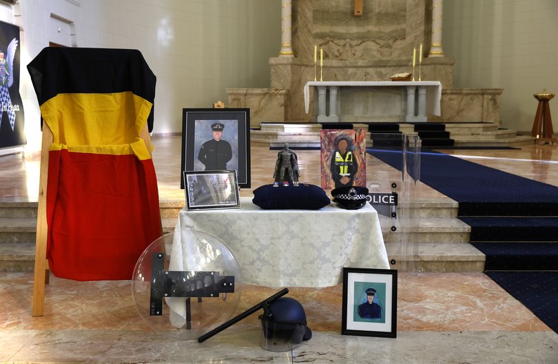 Photographs and personal belongings are displayed prior to the funeral service for Senior Constable Vadim De Waart in Melbourne.