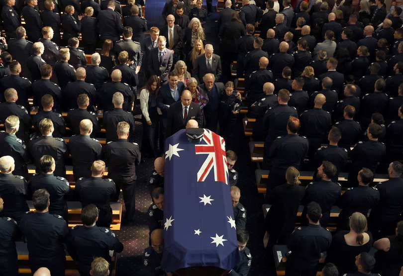 Family members follow the casket out following the funeral service of Senior Constable Vadim De Waart-Hottart.