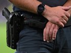 Police found loaded guns on two men during searches at an AFL game.
