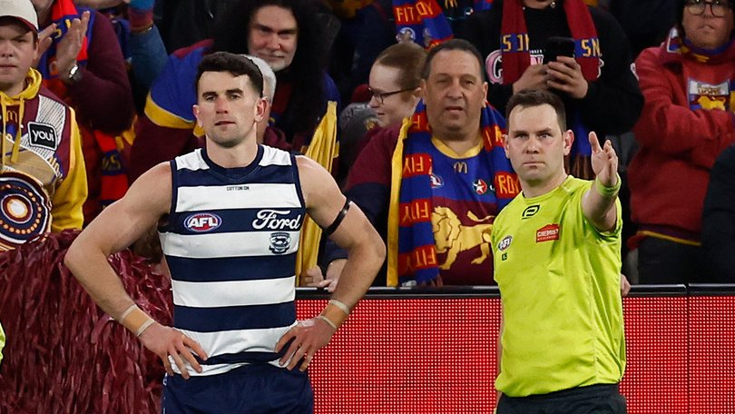 Mark O'Connor of the Cats is seen as Brent Wallace, AFL Field Umpire awards a free kick to Cam Rayner.