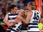 Oliver Dempsey of the Cats is congratulated by Jeremy Cameron and Mark Blicavs after kicking a goal.