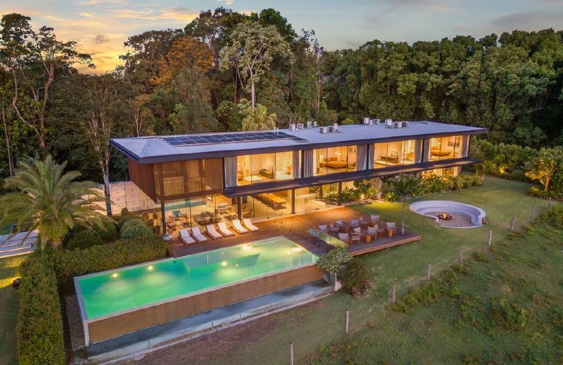 The Modernist-style building is surrounded by a pool and outdoor entertaining.
