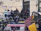 A yellow and white Lisbon funicular, which goes up and down a steep city hill, has crashed. (AP PHOTO)