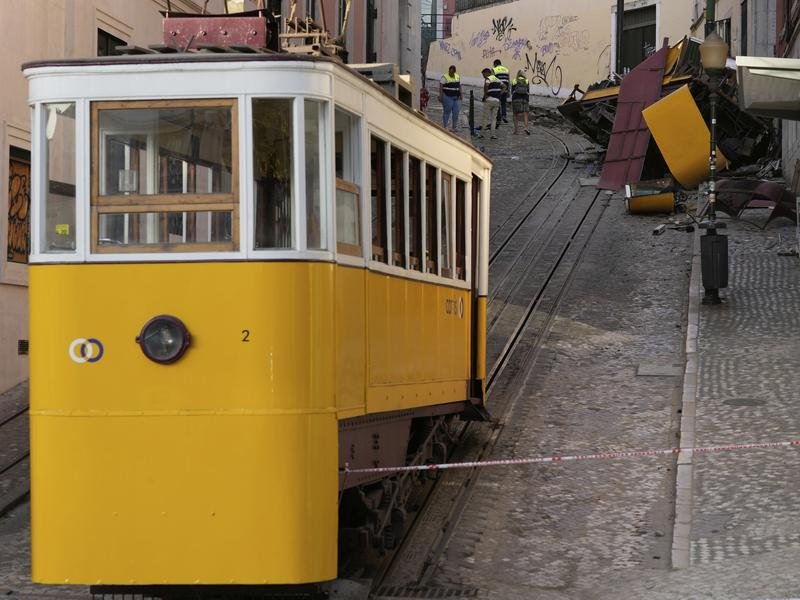 The streetcar's wreckage is cordoned off by police as investigations continue into why to derailed. 