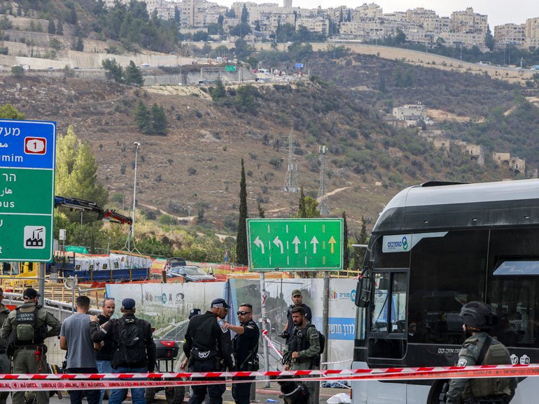 Israeli security forces gather next to a bus in Jerusalem after a suspected terror attack.