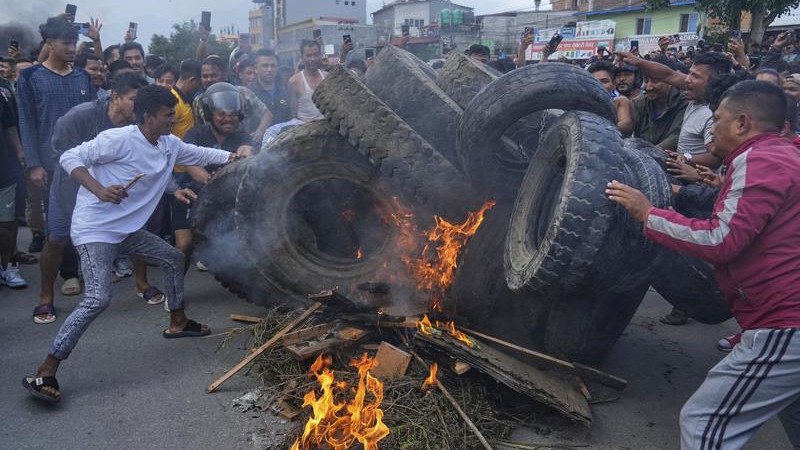 Protesters have burned tyres in defiance of a curfew in Kathmandu as unrest continues.