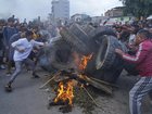 Protesters have burned tyres in defiance of a curfew in Kathmandu as unrest continues.