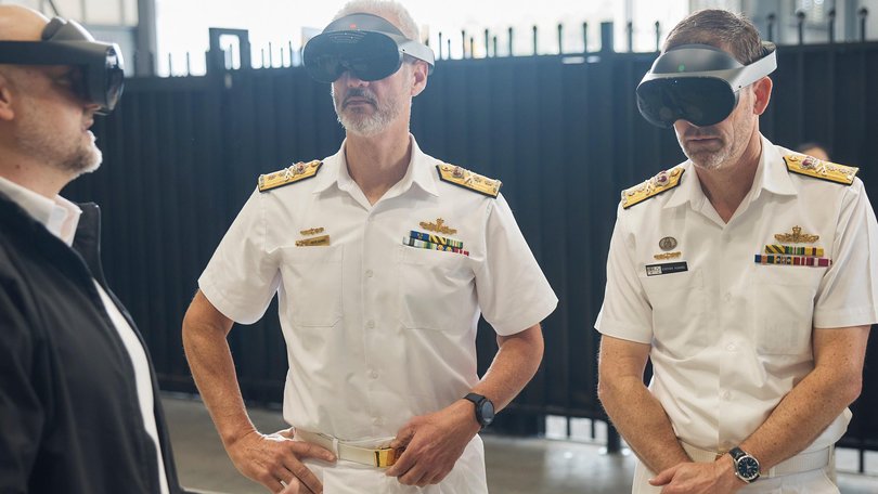 Senior Vice President Engineering, Anduril, Dr Shane Arnott (left) guides incoming and outgoing Head of Navy Capability, Royal Australian Navy, Rear Admiral Peter Quinn and Rear Admiral Stephen Hughes through a virtual reality presentation by Anduril. 
