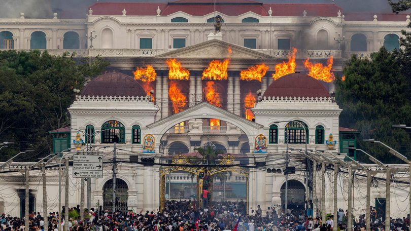 Fire and smoke rise from the Singha Durbar palace, which houses government and parliament buildings, after protesters stormed the premises during violent demonstrations in Kathmandu.