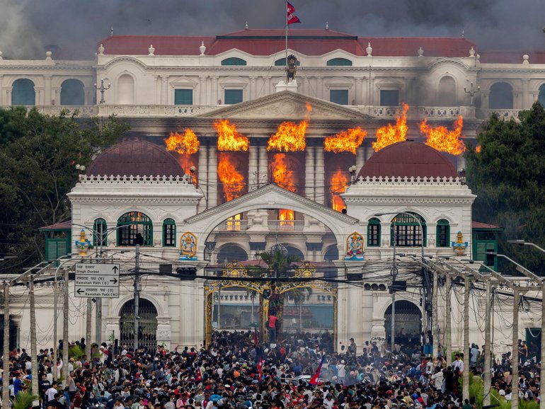 Fire and smoke rise from the Singha Durbar palace, which houses government and parliament buildings, after protesters stormed the premises during violent demonstrations in Kathmandu.