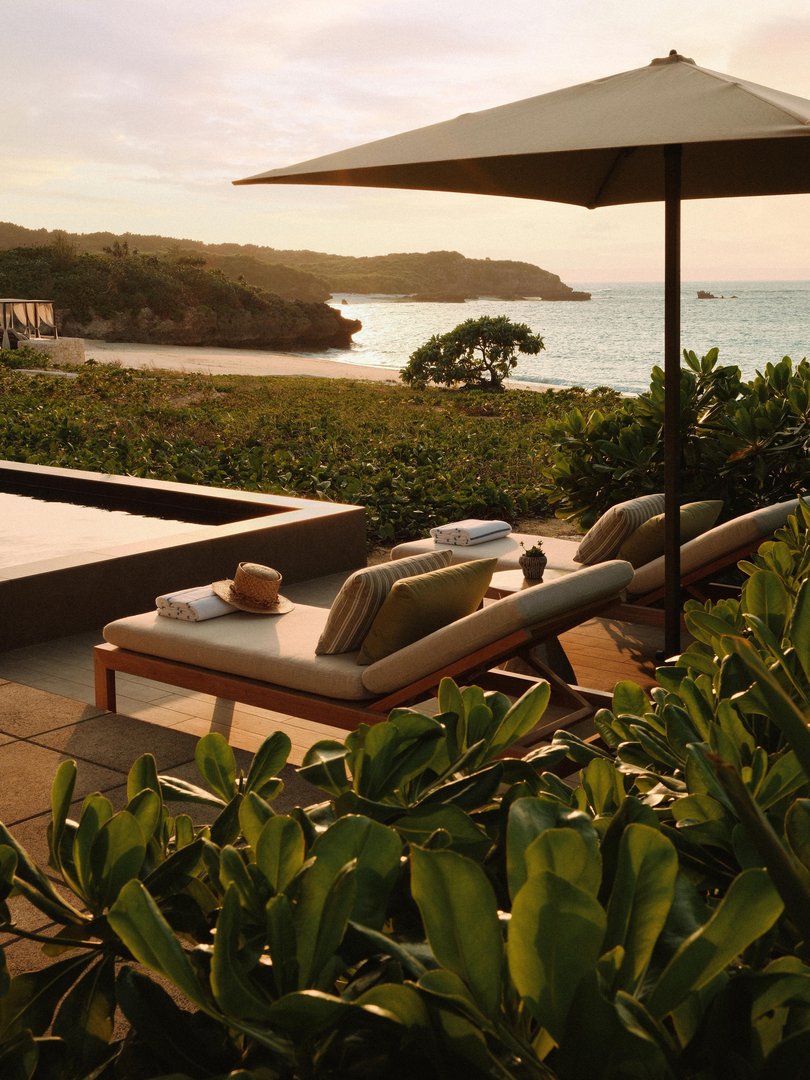 An incredible poolside view looks out on the serene Oura Bay.