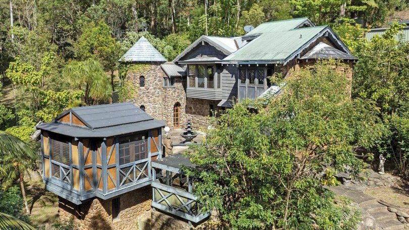 A Tamborine Mountain home complete with turrets, spires and curved stone walls is up for sale. Pic: Bartle Real Estate.