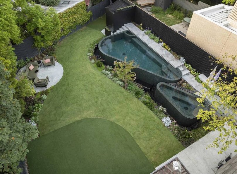 The two curved triangular forms consist of a main pool with an integrated plunge and a detached spa.