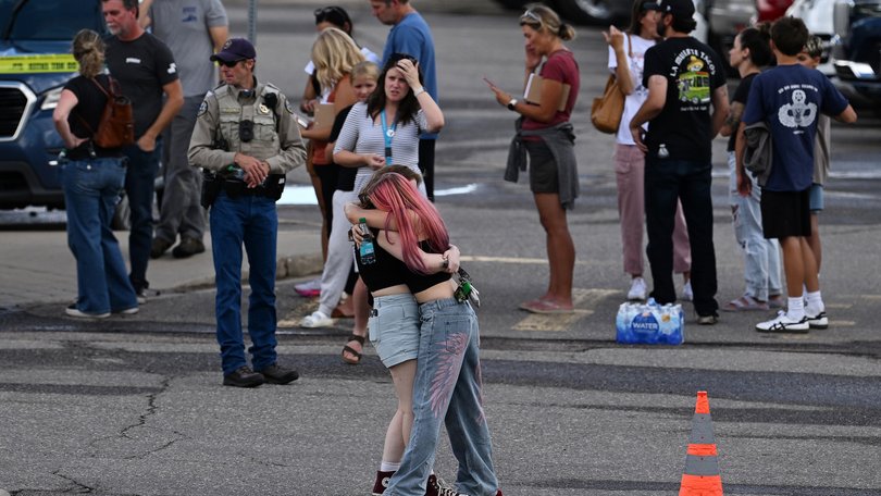 Students reunite with loved ones and classmates outside Bergen Meadow Elementary School after a shooting at Evergreen High School.