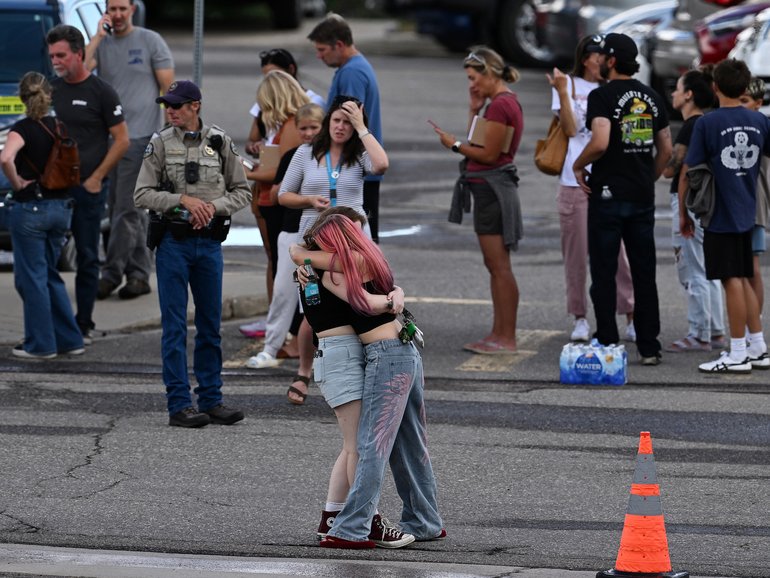Students reunite with loved ones and classmates outside Bergen Meadow Elementary School after a shooting at Evergreen High School.