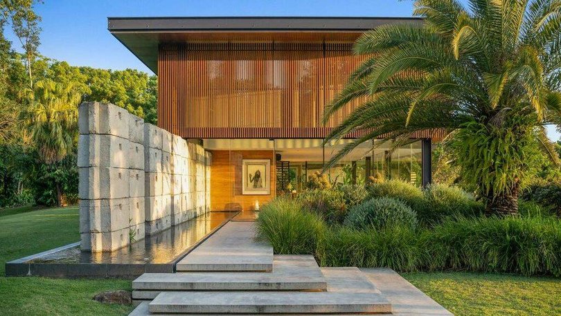 The property includes 21 acres of rolling hills and lush hinterland vistas.