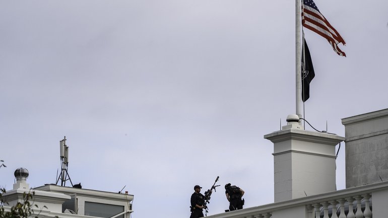Secret Service countersnipers on the roof of the White House where the US flag was lowered to half-staff after Charlie Kirk was killed in Utah.