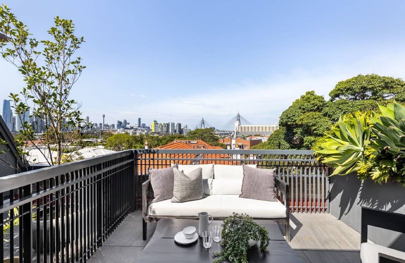 A deck on the dual-level apartment offers city skyline views.