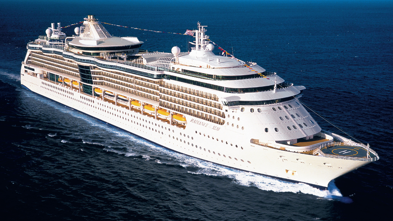 A cruise passenger has been charged after jumping off Royal Caribbean’s Rhapsody of the Seas ship with thousands in cash on him.