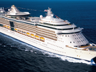 A cruise passenger has been charged after jumping off Royal Caribbean’s Rhapsody of the Seas ship with thousands in cash on him.