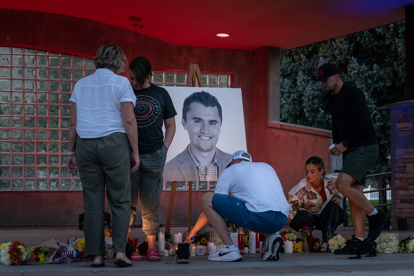 People light candles during a vigil for Charlie Kirk held at a park in Orem, Utah.