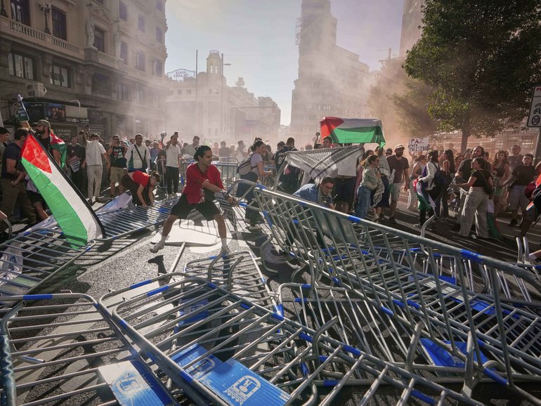Protesters block the road in an attempt to disrupt the twenty-first stage of the Spanish cycling race La Vuelta, from Alalpardo to Madrid in Spain.