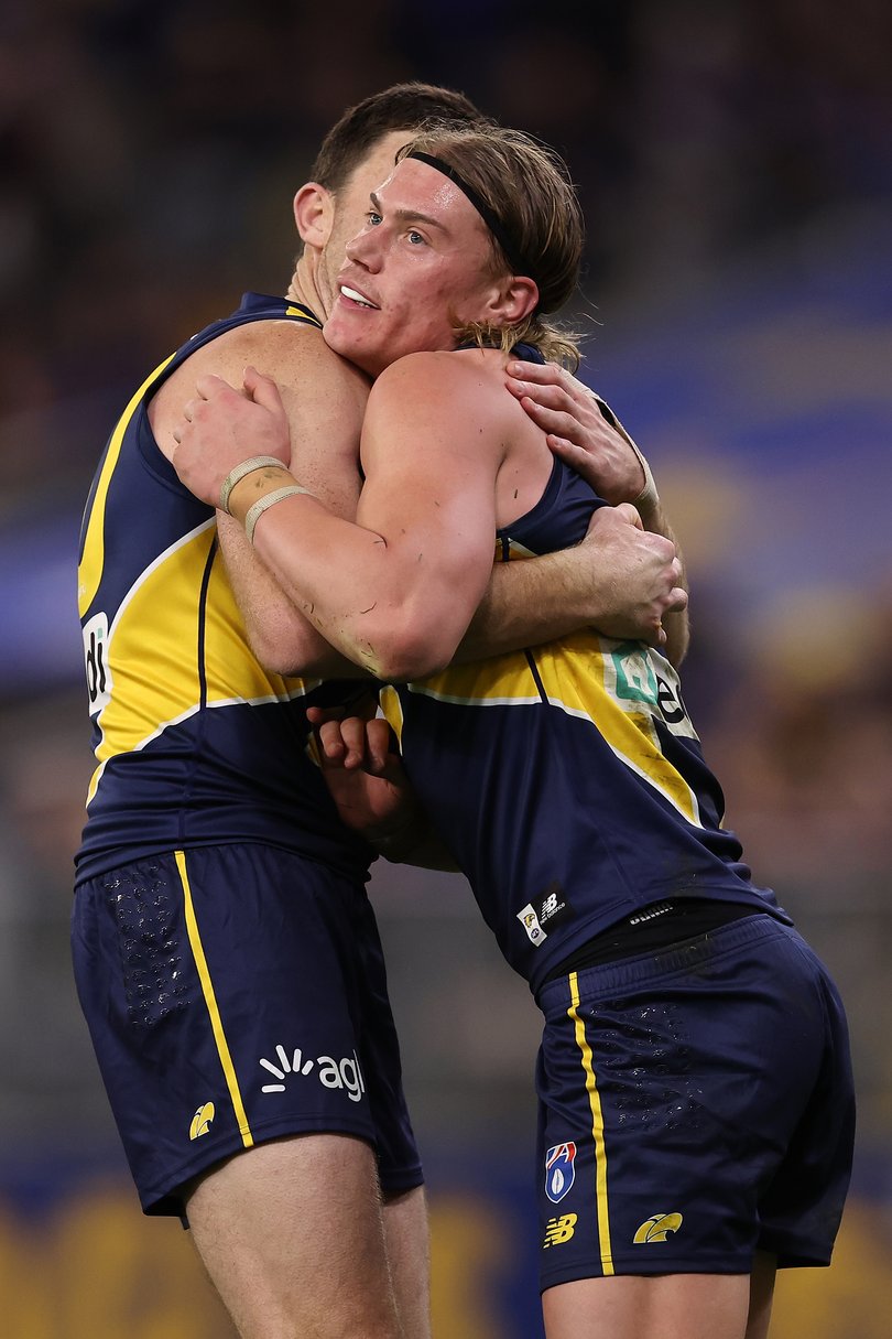 McGovern and Reid embrace during a game.