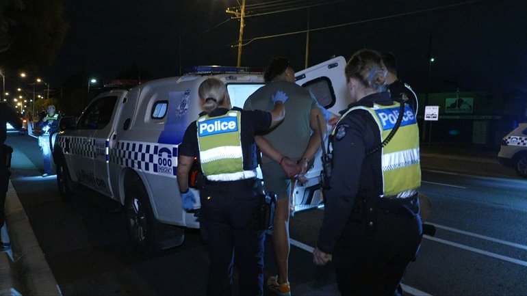 The 22-year-old man was placed in the back of a police van.