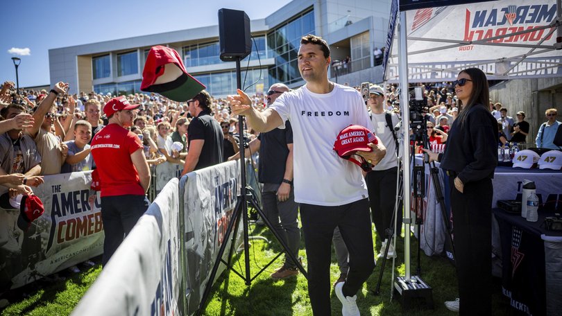 Charlie Kirk hands out hats before speaking at Utah Valley University in Orem, Utah, Wednesday, Sept. 10, 2025. (Tess Crowley/The Deseret News via AP)