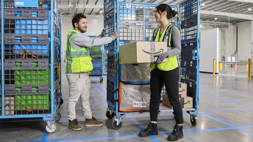 Workers loading up packages for Amazon at an Amazon delivery station in Perth.