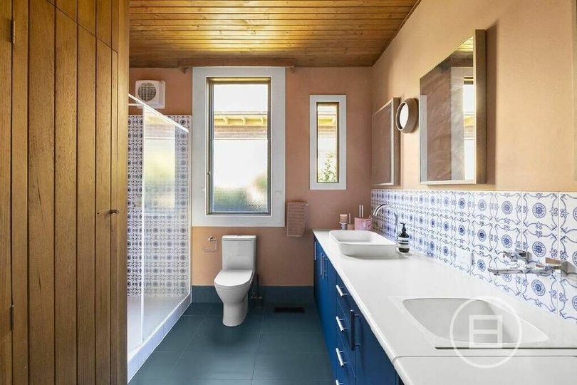 Original features include timber wall panels and retro tiles in the bathroom.