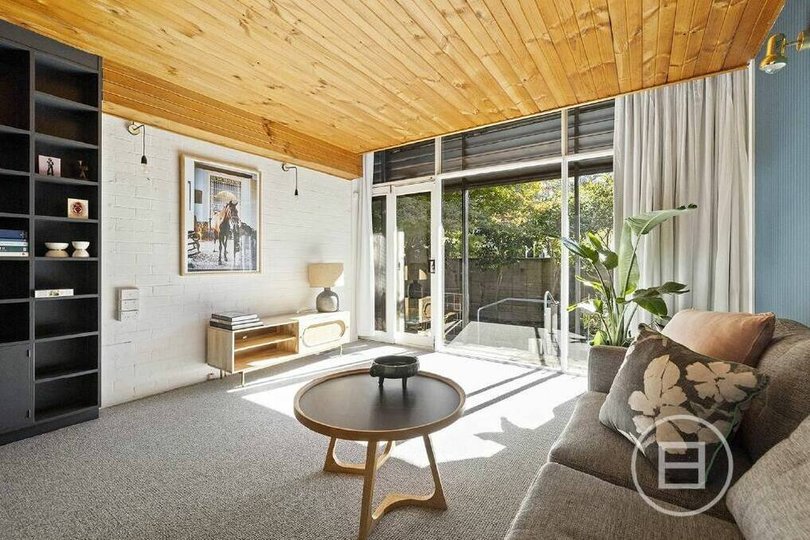 Swan retained the original timber ceiling panels in the living room.