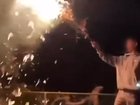 Video has emerged of a young male waving around a branch on fire at the park.