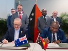 Anthony Albanese and Papua New Guinea Prime Minister James Marape sign the joint communique between both countries on a Mutual Defence Treaty.