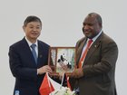 Chinese President Xi Jinping's special envoy and Minister of Ecology and Environment H.E. Huang Runqiu presents a gift to PNG Prime Minister James Marape on Monday.