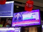 MAGA hats sit atop television screens at the New York Stock Exchange as US Federal Reserve chair Jerome Powell announces rate cuts on the back of poor US jobs data.